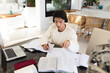 © Wavebreak Media - High angle view of asian teenage boy with books and laptop on table studying while sitting at home