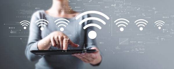 Canvas Print - Wifi theme with business woman using a tablet computer