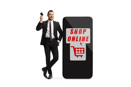 Full length portrait of a businesman holding a credit card and leaning on a mobile phone with text shop online