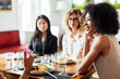 © BONNINSTUDIO/Stocksy - Black woman listening to friend in cafe