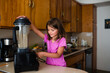 © Maria Manco/Stocksy - child pours green smoothie into cups