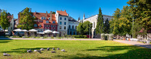 Livu Square In Riga, Latvia In Summer. Panoramic Banner Image. Historic Houses Under Red Tiled Roofs.