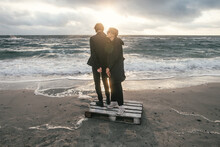 Young Couple Walking At Sea Shore