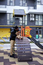 Toddler Having Fun With Father On Playground