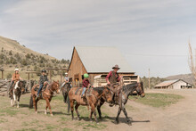 Family Of Cowboys Ride Horses On A Cattle Ranch