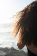 © Tessy Morelli/Stocksy - Detail of long curly wild hair in the sunlight