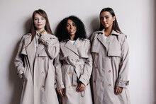 Multiracial Women In Similar Trench Coats