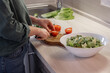 © Milles Studio/Stocksy - Crop woman cutting tomato for salad