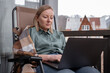 © Milles Studio/Stocksy - Woman using laptop on terrace