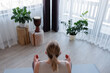 © Milles Studio/Stocksy - Woman meditating near windows at home