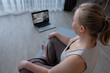 © Milles Studio/Stocksy - Female watching meditation video on laptop