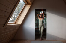 Barefoot Woman Stretching In Doorway