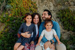 © Erin Brant/Stocksy - Beautiful happy family seated on sand dune
