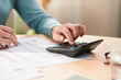 © Martí Sans/Stocksy - Crop person managing personal money at home