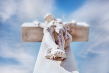 A Stone Statue Of Jesus Christ On The Cross.