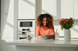 © Elena Kharichkina/Stocksy - Smiling young woman enjoys using digital tablet
