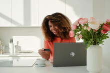 Positive Young Woman Using Laptop And Credit Card At Home
