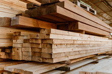 Detail image Pile of Wooden boards at lumber mill in a barn