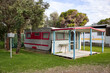 © Rowena Naylor/Stocksy - Cute retro caravan and shack