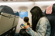 © Ezequiel Giménez/Stocksy - Mother and daughter in airplane