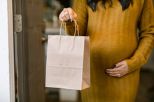 Anonymous Pregnant Woman With Shopping Bag