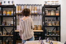 Woman Picking Organic Cereal  In Zero Waste Store