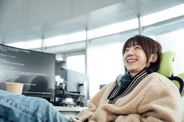 Young business woman smiling at computer