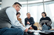© ZQZ Studio/Stocksy - Group of business people brainstorming during a meeting