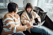 © ZQZ Studio/Stocksy - Two casual businesswoman talking in office