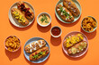 © Pixel Stories/Stocksy - Finger food: grilled hot dogs with condiments and toppings