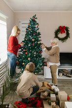 Caucasian Family Decorating Home For Christmas Days