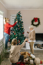 Women Family Decorating Home For Christmas Days