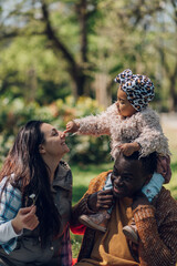 Multiracial family having fun in the park