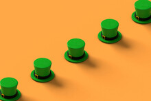A Row Of Green St.Patrick Hats On Orange Background