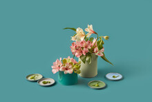 Tin Cans, Lids And Spring Flowers Over Green Background