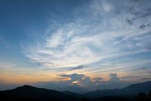 Cloudscape At The Sunset With The Silhouette Of Mountains