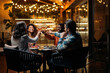 © Santi Nuñez/Stocksy - Top view of group of diverse friends clinking glasses