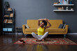 © Elena Kharichkina/Stocksy - A woman does a stretch after a workout at home