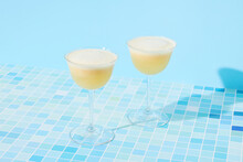 Two Banana Daiquiri Cocktails On Blue Background 