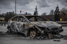 Burned Out Car Left On Asphalt Road In Ukraine