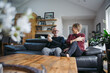 © Ameris Photography Inc./Stocksy - Older couple looking happy together on couch.