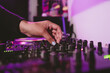 © Felipe Barrera/Stocksy - Hands of DJ operating a sound mixer