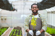 © Quality Stock Arts - black worker in plant agriculture farm happy smile hand holding small tree