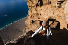 Woman Hiking On The Rocks