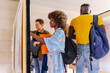 © VICTOR TORRES/Stocksy - Diverse friends looking at their exam results on a bulletin board