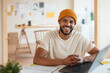 © BONNINSTUDIO/Stocksy - Cheerful black man in home office