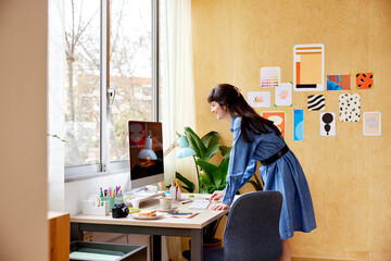 Happy female freelancer using computer