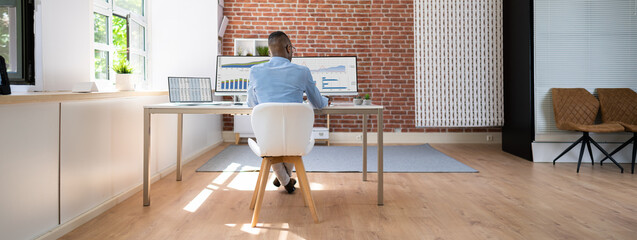 Poster - Businessman Analyzing Financial Graphs On Computer At Desk