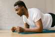 © STUDIO TAURUS/Stocksy - Healthy African male working out indoors