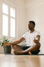 Man Meditating Indoors